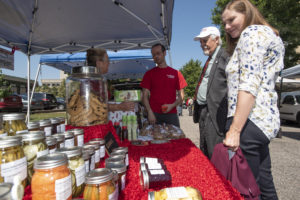 Customers shopping for produce at a farmers market