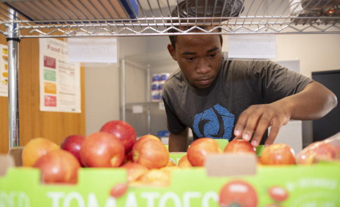 Bryant Grant is the student worker. Bryant Grant, student volunteer at the Cardinal Cupboard.