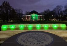 A look back at a very unusual – and unprecedented – year at UofL Picture of the university oval entrance and Grawemeyer Hall lit up at night in green to honor COVID-19 victims.