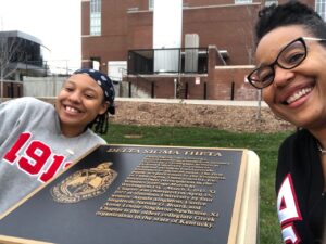 Photo of Dr. Beverly Frye and Kennedy Frye posing in front of the Delta Sigma Theta NPHC marker.