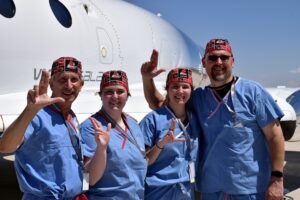 UofL astrosurgery team members George Pantalos, bioengineering student Sienna Shacklette, bioengineering student Clara Jones and Tommy Roussel in front of the Virgin Galactic VSS Unity SpaceShipTwo at Spaceport America in New Mexico. Photo courtesy Virgin Galactic.