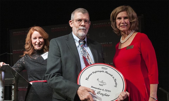 Al Saylor, RN, one of the 2014 Florence Nightingale Award winners, with his plaque