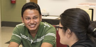 International students Mohammad Shamim Reza of Bangladesh and Sunita Khanal of Nepal waited last week at the International Center for a trip to get Social Security cards.