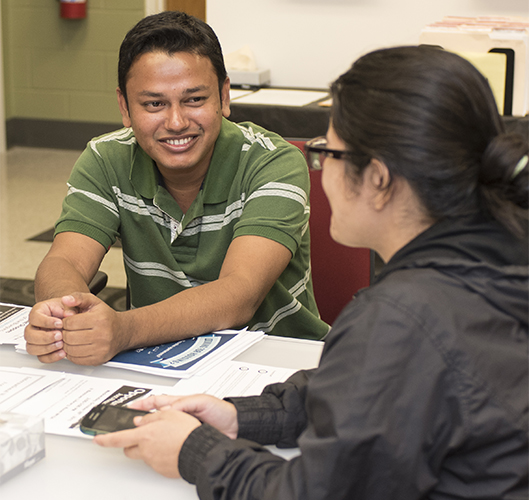International students Mohammad Shamim Reza of Bangladesh and Sunita Khanal of Nepal waited last week at the International Center for a trip to get Social Security cards.