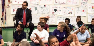 Interim College of Business Dean Rohan Christie-David with students from Portland Elementary.