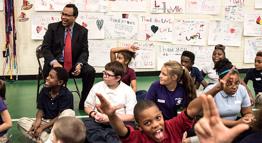 Interim College of Business Dean Rohan Christie-David with students from Portland Elementary.