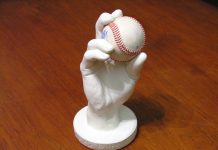 Custom-made 3D plaster cast of hand holding a baseball.