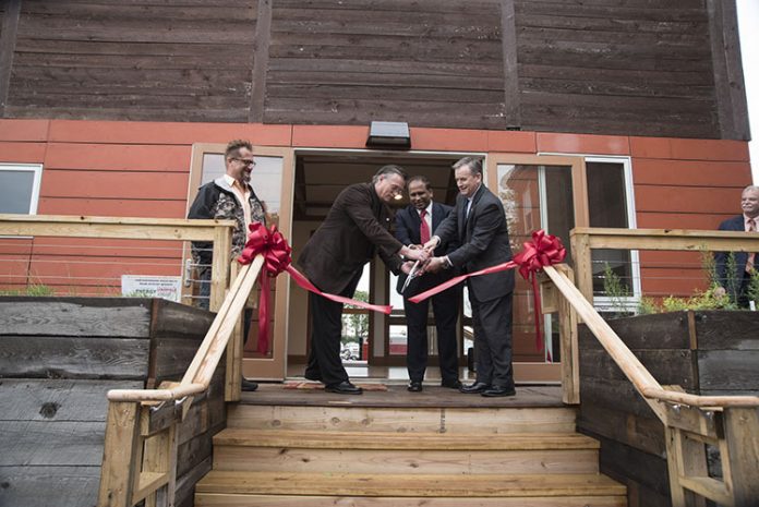 A ribbon cutting ceremony celebrated the Conn Center's solar-powered Phoenix House. From left is Andrew Marsh, asst. director of the Conn Center, Mark McGinley, Speed professor, Mahendra Sunkara, director of the Conn Center, and John Usher, acting dean of the Speed School.