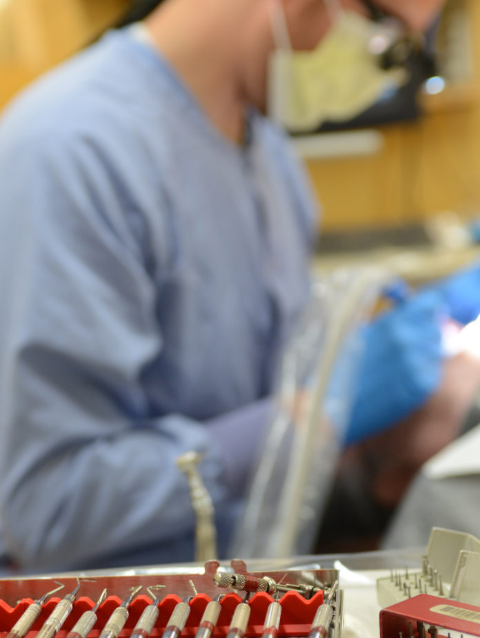 Dental student treats a patient at the School of Dentistry.