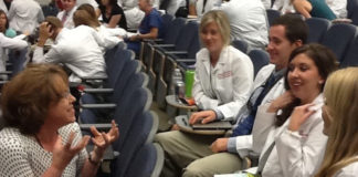 Vida Vaughn, Kornhauser clinical librarian, interacts with dental students during a seminar break.