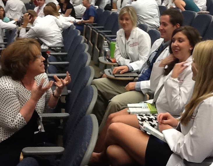 Vida Vaughn, Kornhauser clinical librarian, interacts with dental students during a seminar break.