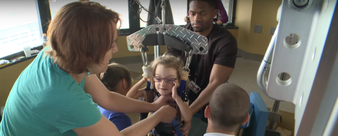 Locomotor training is helping Emmalie, who was unable to walk after suffering a spinal cord injury, take steps, sit up on her own and improve her range of motion.