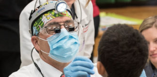 A child receives dental care from UofL.