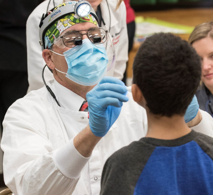 A child receives dental care from UofL.