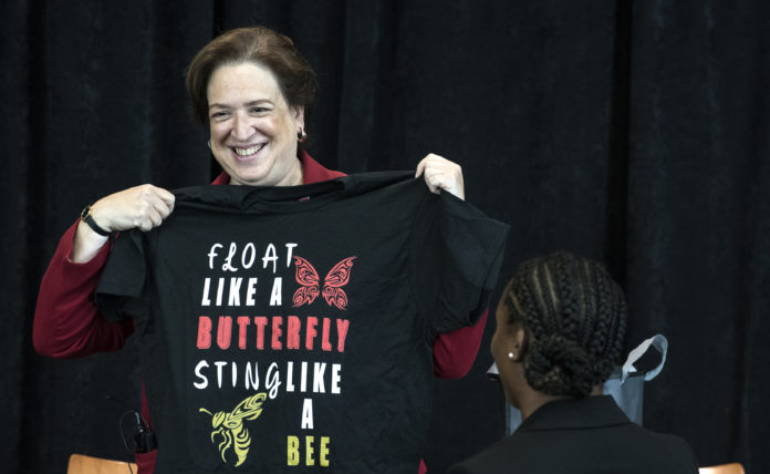 Justice Kagan shows off a t-shirt given to her during her Louisville visit.