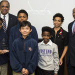 Acting UofL President Neville Pinto, far left, and Dan Hall, far right, vice president of the Office of Community Engagement, stand with students from West End School. The school won a Community Engagement Award for its dedication to working with UofL.