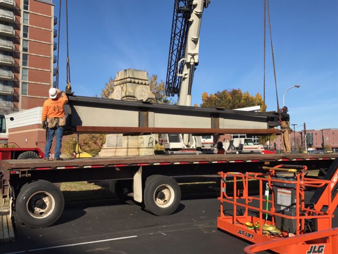 Workers loaded a large section of the confederate monument on a truck during deconstruction of the monument Sunday, nov. 20. The monument will be reassembled in Brandenburg, where it will join other monuments in a historical display.