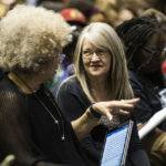 Cate Fosl, director of the Anne Braden Institute, speaks to activist Angela Davis.