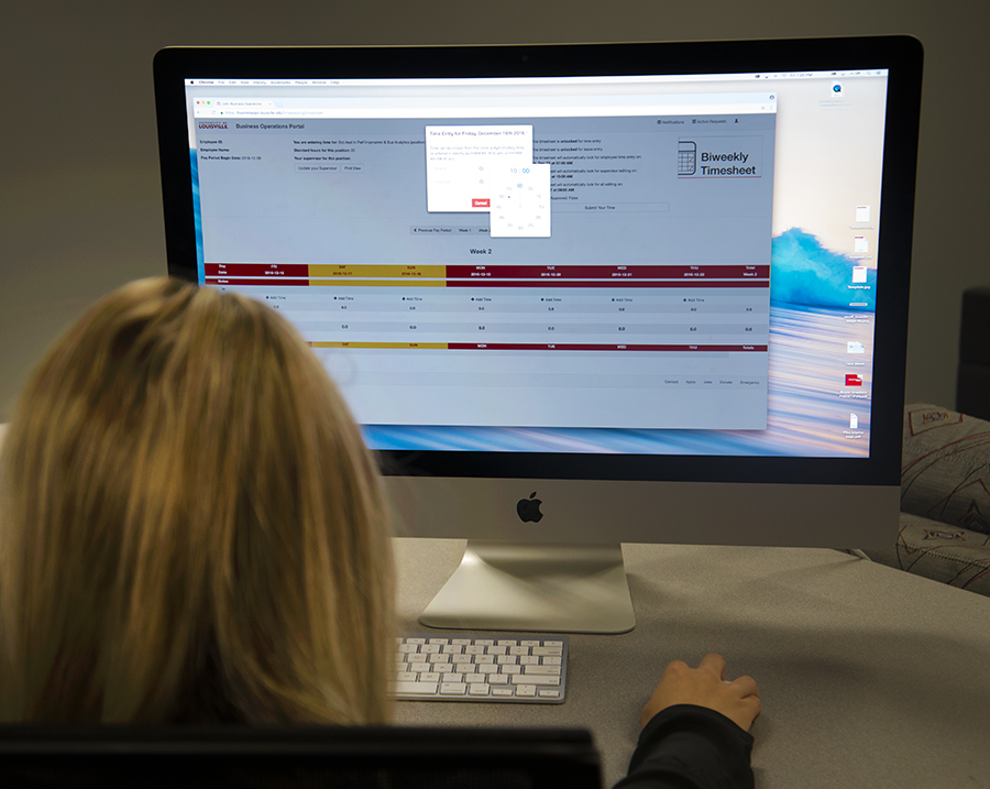 A UofL employee works on a new web-based time sheet.