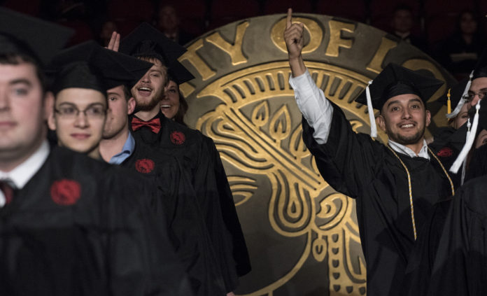 Nearly 1,000 graduates took part in the Dec. 15 commencement ceremony at the KFC Yum! Center.