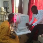 A surplus auto refractor, donated by UofL, is used to determine a patient’s proper eyeglass prescription in Tamale, Ghana