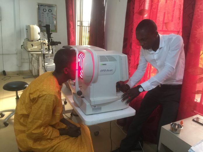 A surplus auto refractor, donated by UofL, is used to determine a patient’s proper eyeglass prescription in Tamale, Ghana