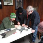 (Left to right) Professors Daniel Krebs (History) and DJ Biddle (Geography & Geosciences), with Vince DeNoto, director of the National Center for Geospatial Excellence at Jefferson Community & Technical College, planning the flight path of the drone over the battlefield.