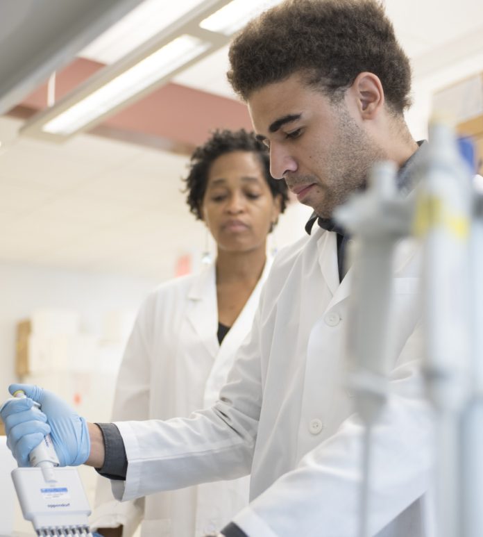 LaCreis Kidd, Ph.D., with Cancer Education Program participant Thomas Packer, Jr.