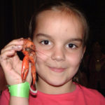 Hannah Kemper attending her first Crawfish Boil in the Red Barn when she was 8 years old. She is now a sophomore at UofL and one of the event's organizers this year.