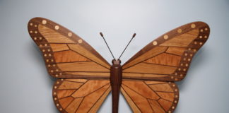 Associate biology professor Steve Yanoviak’s wood sculpture, titled “Claire’s Monarch,” spans 34-by-25 inches and is handcrafted using Kentucky hardwoods