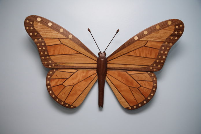 Associate biology professor Steve Yanoviak’s wood sculpture, titled “Claire’s Monarch,” spans 34-by-25 inches and is handcrafted using Kentucky hardwoods