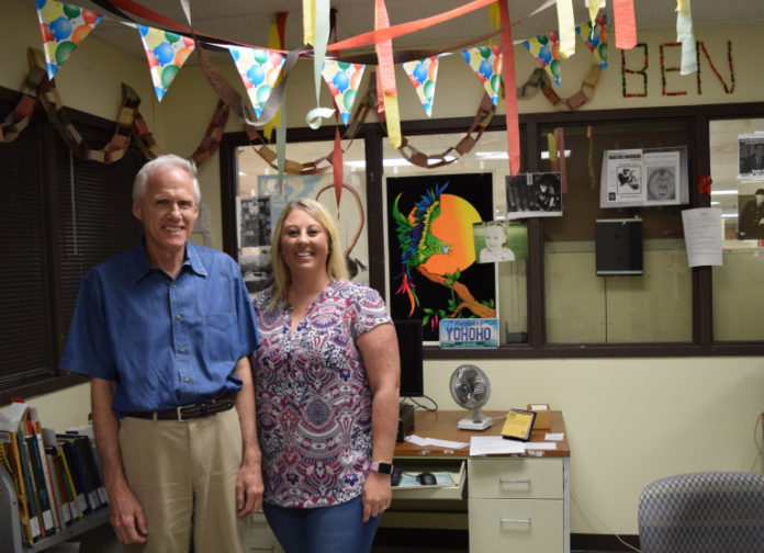 Ben King and his former student assistant Stacey Alvie stand in King’s decorated office in Ekstrom Library.