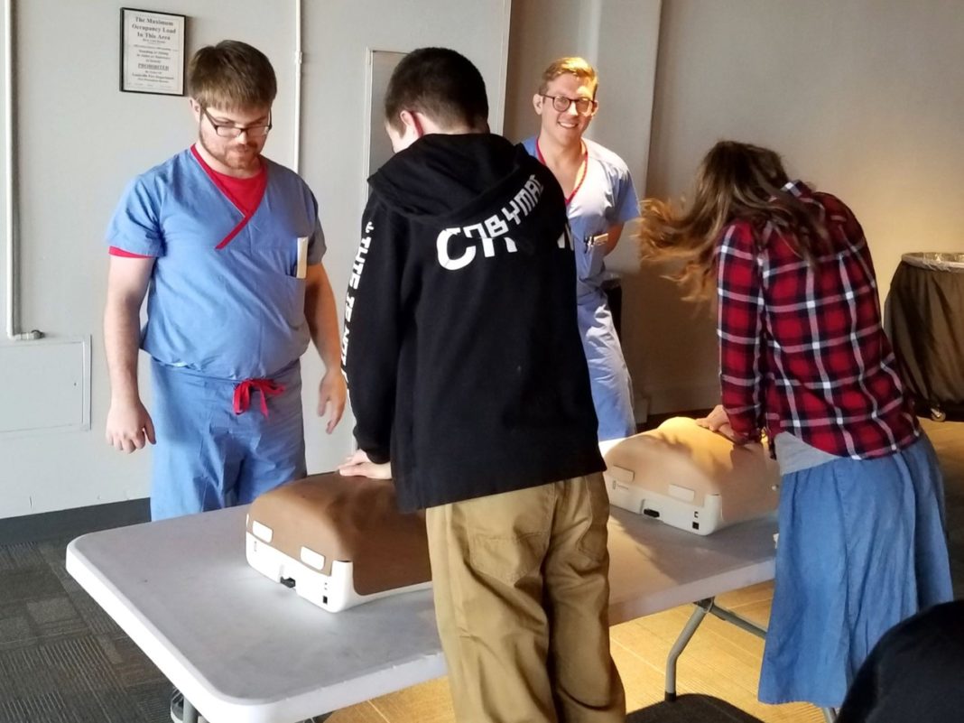 Students practice CPR at the Kentucky Science Center as part of Research!Louisville