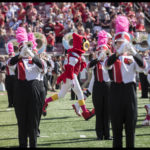 Louie makes his way through the marching band during a 2017 football game.