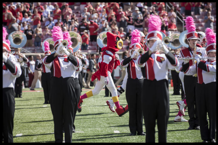 Louie makes his way through the marching band during a 2017 football game.