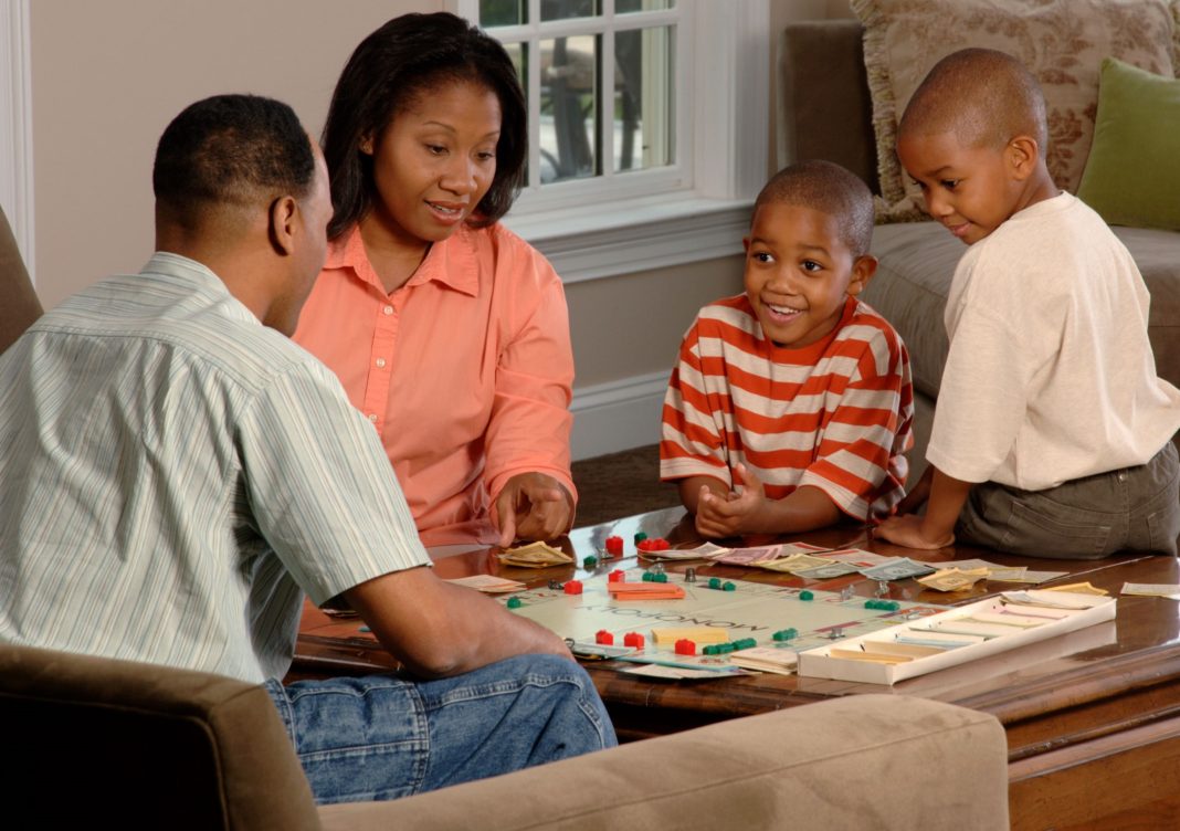 family playing board game