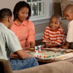 family playing board game