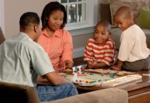 family playing board game
