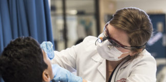 UofL dental student provides screening for a child.