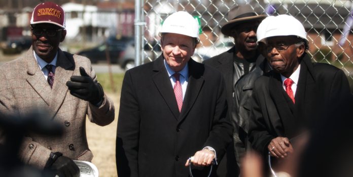 Interim president Greg Postel speaks during Passport Health Plan's groundbreaking ceremony. UofL will lease space in the new building in west Louisville.