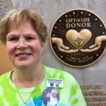 Donna Edwards, whose son Mike became an organ donor at age 25 after he died from an accident at work, is shown Friday in front of the new The Gift of Life Donor Memorial at University of Louisville Hospital after its unveiling.