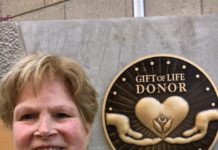 Donna Edwards, whose son Mike became an organ donor at age 25 after he died from an accident at work, is shown Friday in front of the new The Gift of Life Donor Memorial at University of Louisville Hospital after its unveiling.
