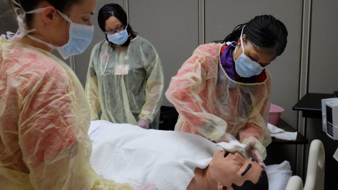 UofL Master's Entry into Professional Nursing students train in a clinical simulation. UofL Master's Entry into Professional Nursing students train in a clinical simulation.