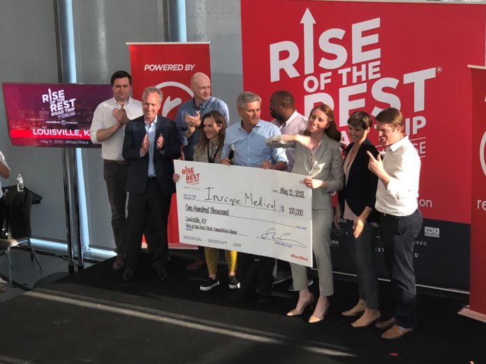 Maggie Galloway (center front, in the tan blazer), CEO of Inscope Medical Solutions, collects her prize from AOL co-founder Steve Case (to Galloway’s left) after winning the Rise of the Rest pitch competition at the UofL Speed Art Museum.