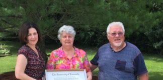 Professor Jasmine Farrier presents Andrew Cecil's degree to his parents seven years after Andrew's death.