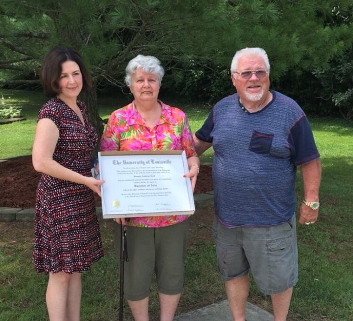 Professor Jasmine Farrier presents Andrew Cecil's degree to his parents seven years after Andrew's death.