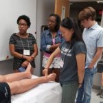 SHPEP participants Jalajaa Slaton, Sydney Johnson, Caroline Xiong and Noah Clements in the UofL School of Medicine simulation center