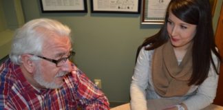 Older adult talking with behavioral health worker.