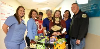 Family delivers Halloween baskets to UofL Hospital NICU.