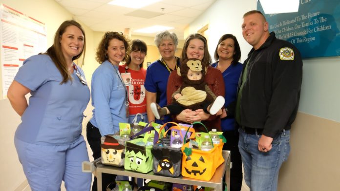 Family delivers Halloween baskets to UofL Hospital NICU.